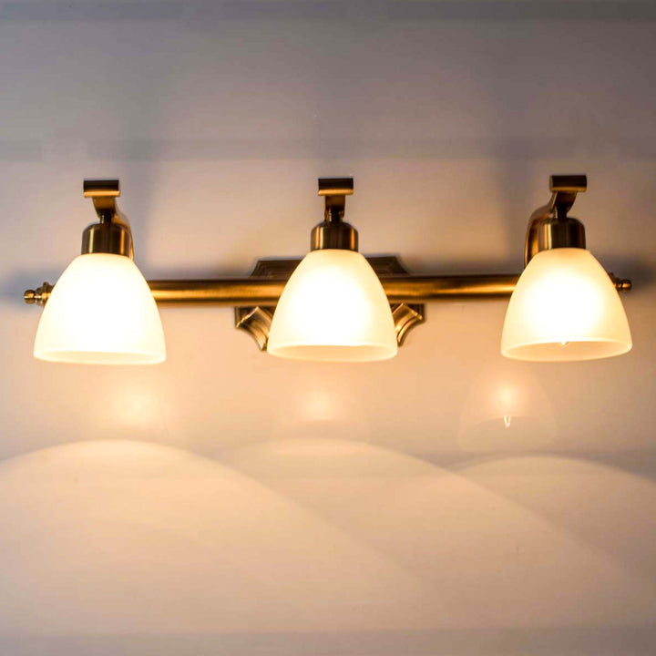 Bravo 3 lights mirror light in brass ant finish with frosted glass shades.