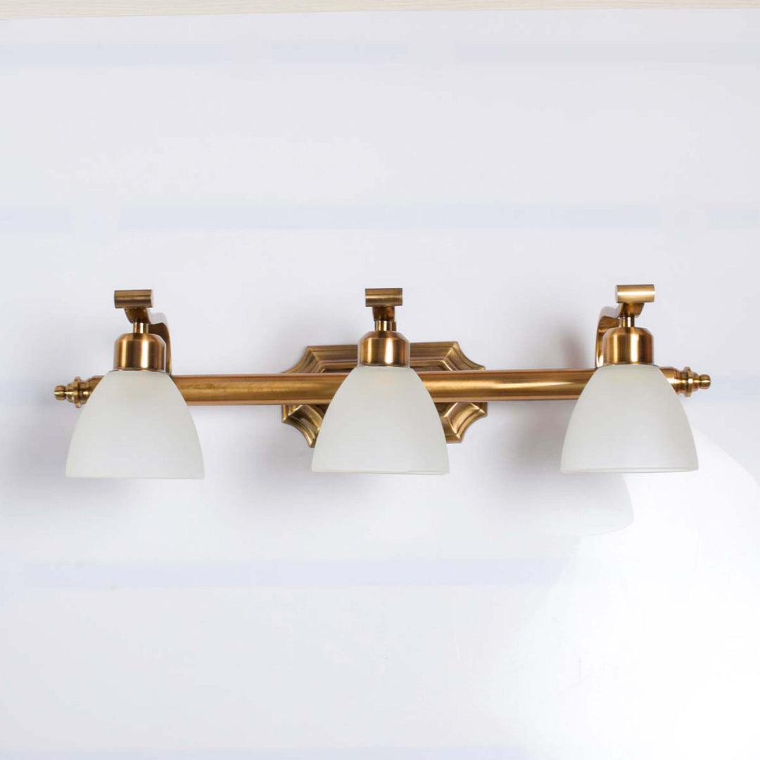 Bravo 3 lights mirror light in brass ant finish with frosted glass shades.