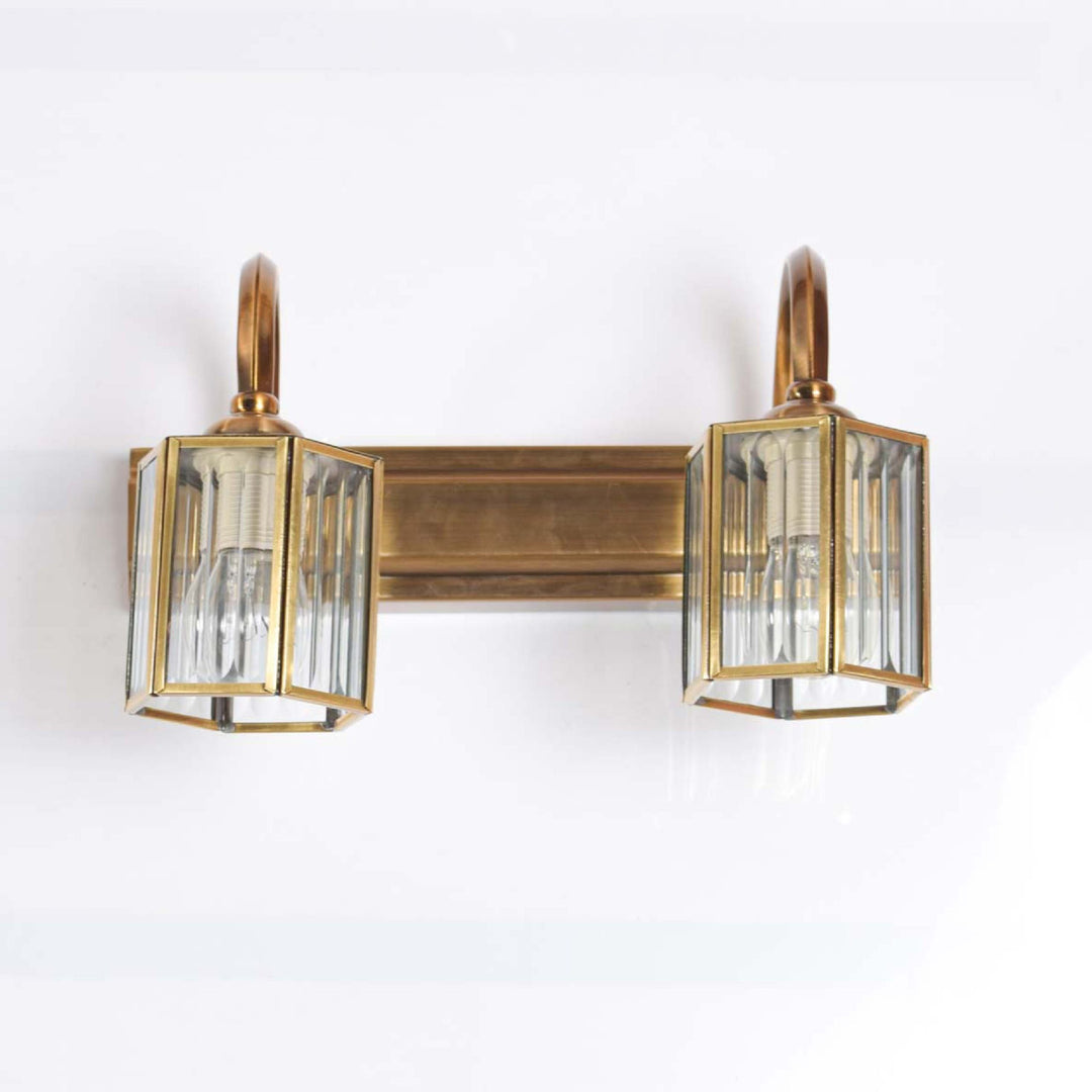 Neptunus 2 lights mirror light in brass ant finish with frosted glass shades.