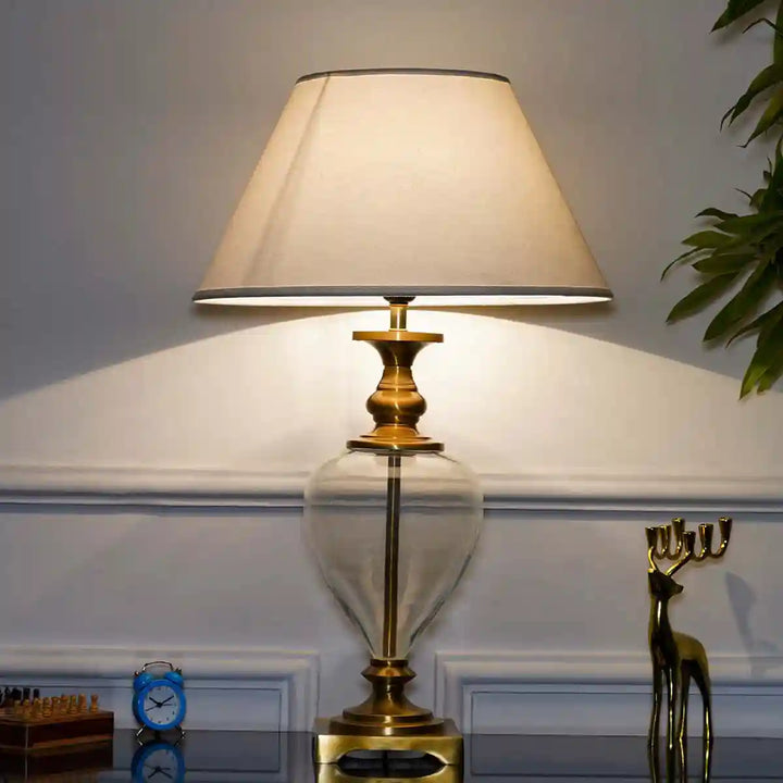 Hinton Clear Glass And Brass Finish Metal Table Lamp With Cotton White Shade